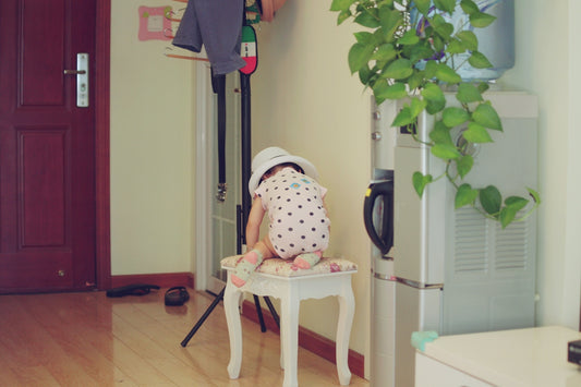 a little girl sitting on a chair in a room