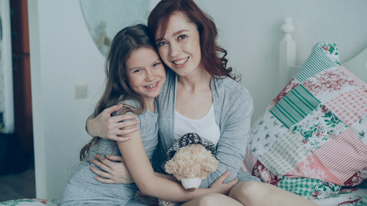 A mother and daughter smile happily together