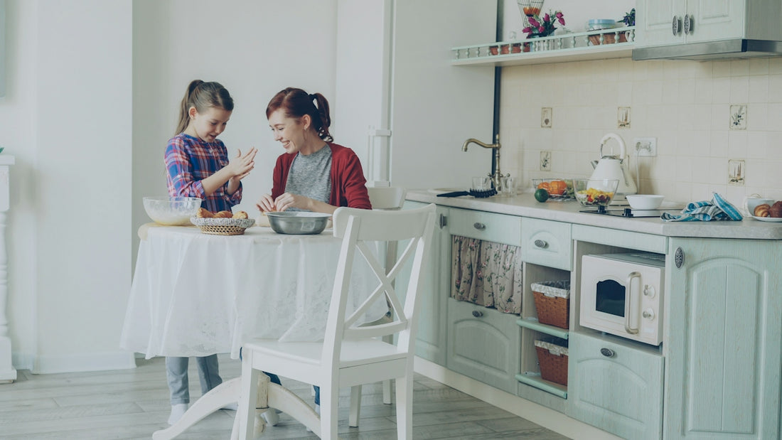 A mother and daughter bake together in the kitchen