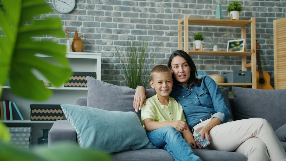 Mother and son sitting on a couch together