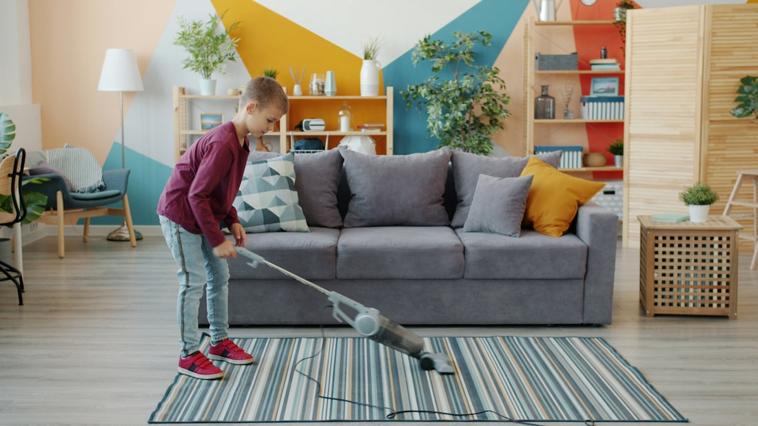 Young girl vacuuming a striped rug in a living room