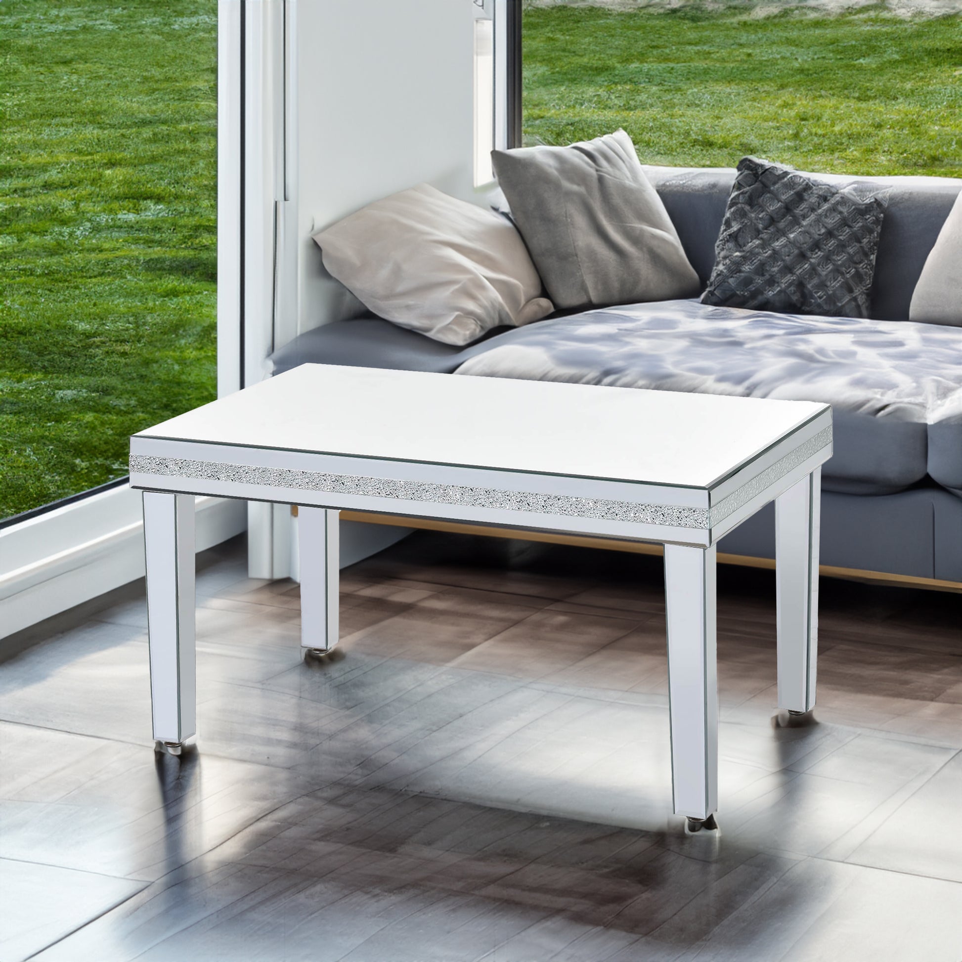 The ON-TRANS stylish modern glass mirrored coffee table features a crystal design and adjustable height legs in silver eprolo