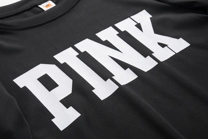 Black sweatshirt fabric close-up with large white “PINK” letter print