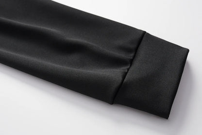 Black two-piece set sleeve cuff detail with smooth fabric fold
