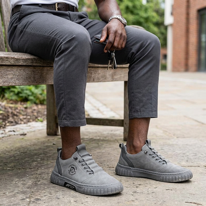 Black man wearing the grey casual shoes